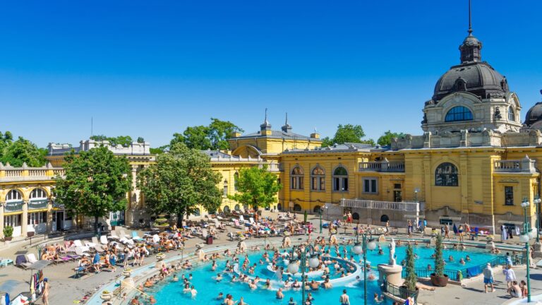 The grand yellow neo-Baroque facade of Széchenyi Medicinal Bath in Budapest, Hungary