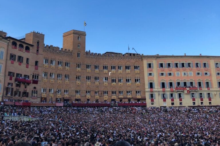 Crowds gather in Piazza del Campo to watch the Palio di Siena horse race.