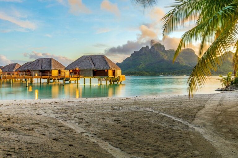 a small resort in bora bora with a mountain in the background