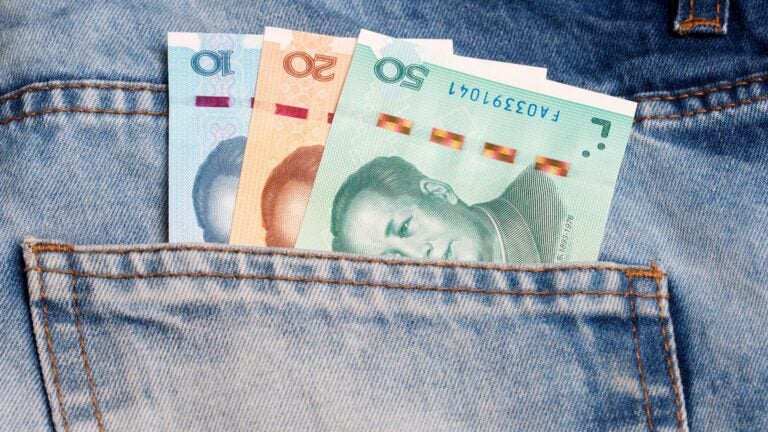 Chinese yuan banknotes tucked into the pocket of a pair of blue denim jeans.