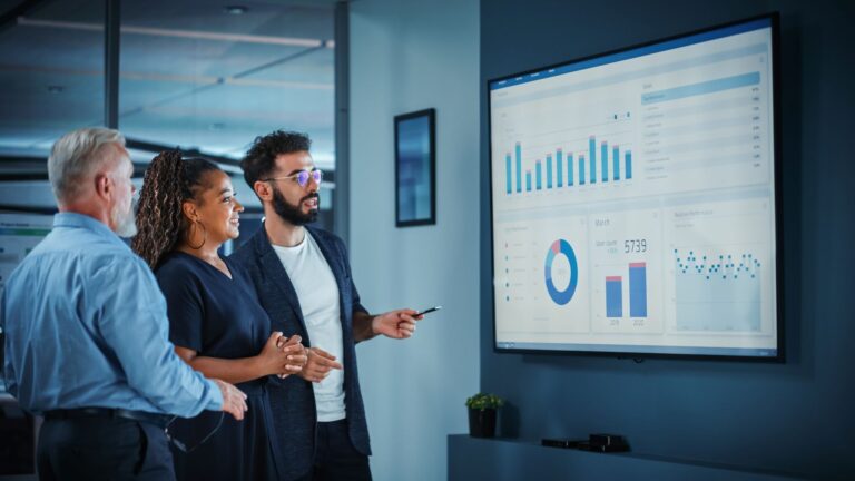 data science intern with his colleagues, looking over a report