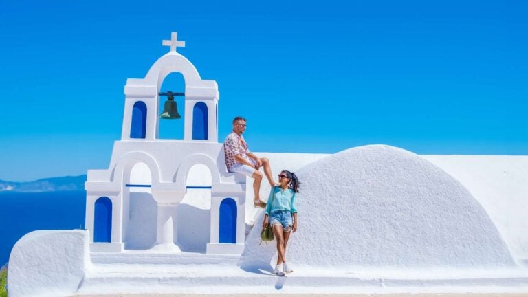 greek rooftops with some people standing close to them