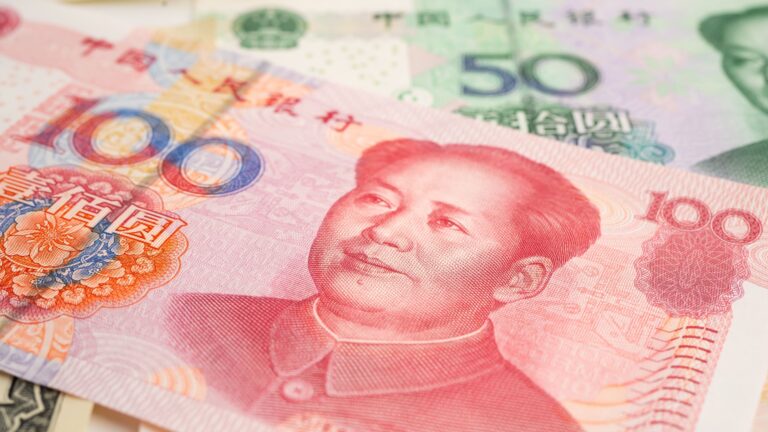 A stack of Chinese yuan renminbi banknotes fanned out, showing the currency used for cash transactions in China.