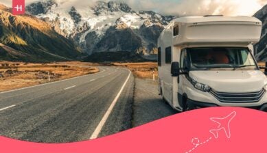 Motorhome on a scenic New Zealand road beside snow-capped mountains