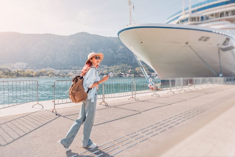 Tourist with backpack walking near cruise.