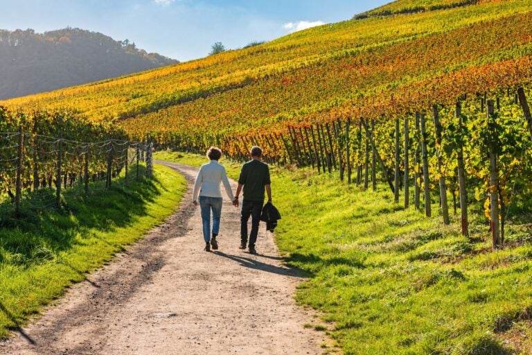 A couple on the red wine hiking trail in the vineyards.