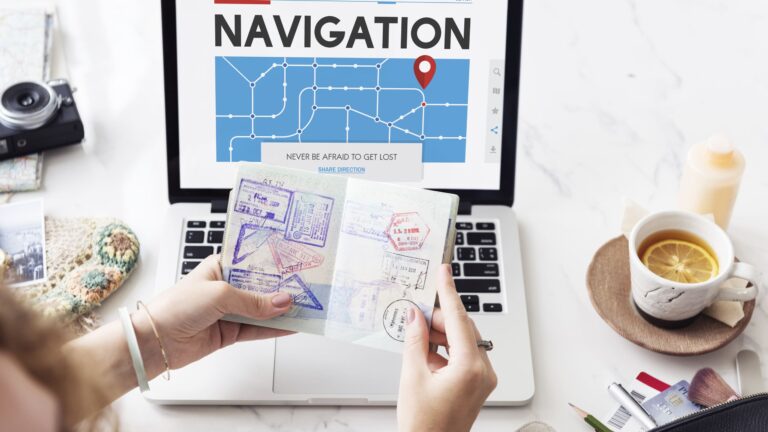 Smartphone displaying a GPS navigation map with directions, placed next to a passport on a flat surface.