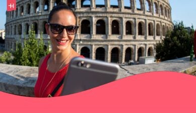 woman taking a selfie in front of colosseum