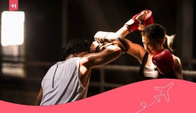 Student athlete training in boxing session with coach, highlighting strength, focus, and performance.