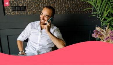 man using a phone in a coffee shop