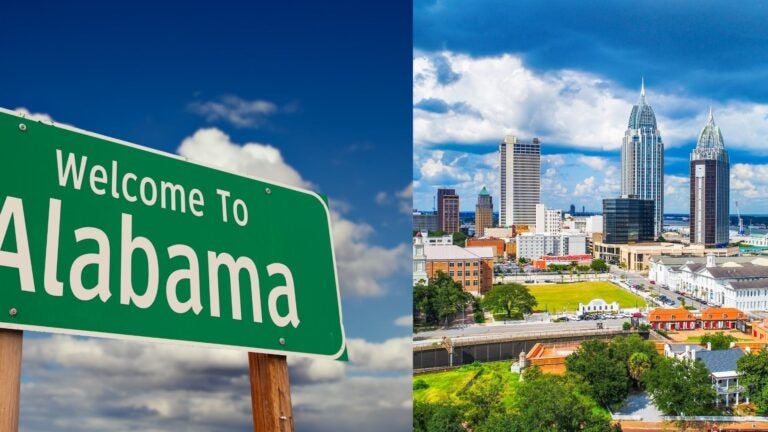 A Welcome to Alabama sign beside the Mobile skyline.