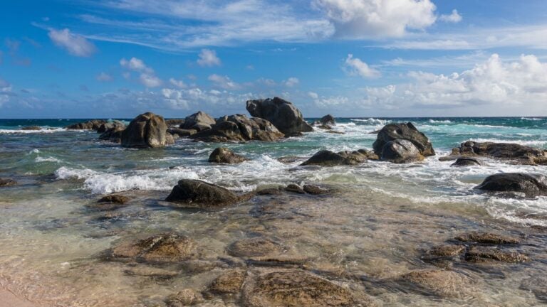 Turquoise water and rocky coastline at Westpunt Beach on the northern shore of Aruba