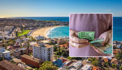 Aerial view of Bondi Beach in Sydney with an inset of hands counting Australian one hundred dollar banknotes.