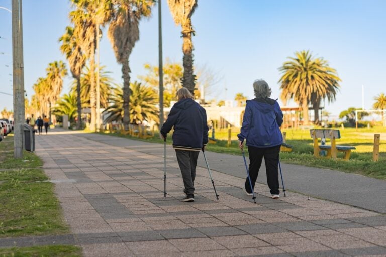 Two elderly retirees taking a walk around the neighborhood in Virginia.