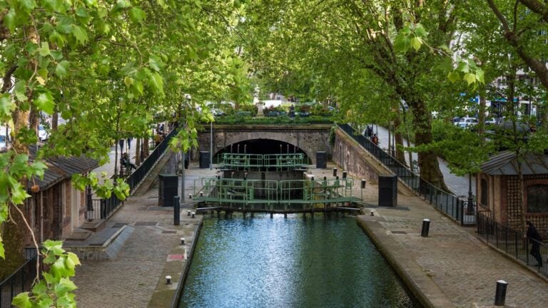 Calm, tree-lined Canal Saint-Martin in Paris on a quiet summer day