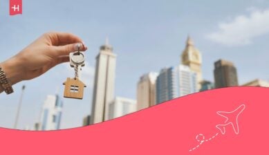 House keychain held against the Dubai skyline, representing the cost of living and housing expenses in Dubai.