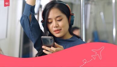 Asian woman listening to music on the subway