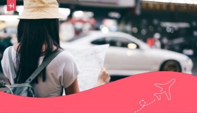 Woman waiting for her taxi to arrive at the side of the street