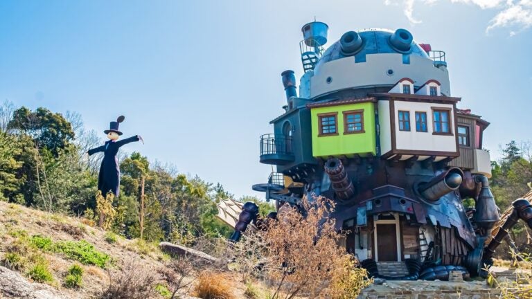 Landscaped grounds and Studio Ghibli–themed structures set among greenery at Ghibli Park near Nagoya