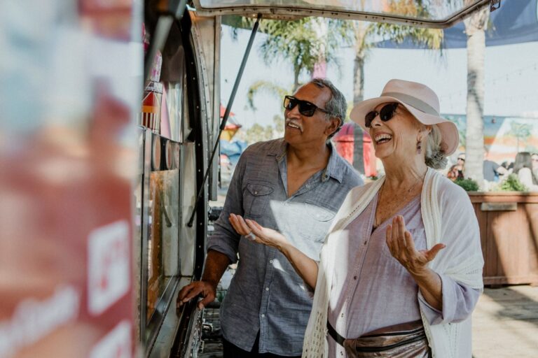 an elderly couple laughing and talking to a food truck owner in Tennessee 