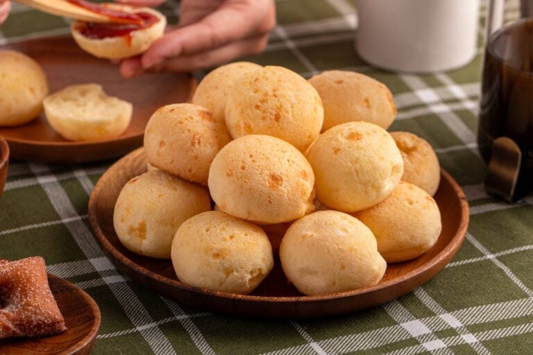 dish full of pao de queijo with guayaba on a side