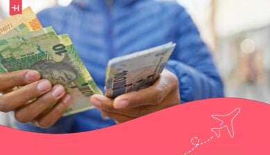 A woman holding a card payment terminal to process a transaction