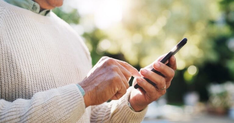 elderly person using a mobile phone