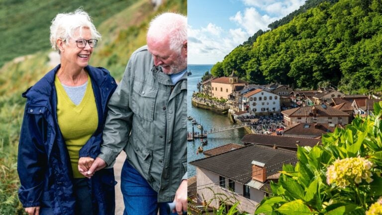 Retired couple walking beside the coastal town of Pasai Donibane near San Sebastián.