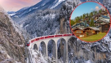 A red Swiss train crossing a snow-covered stone viaduct through the Alps, with an inset circle showing wooden chalets of a car-free alpine village