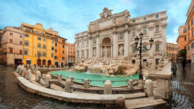 Trevi Fountain in Rome lit by soft morning light, nearly empty of visitors