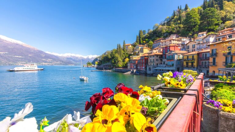 Bright flowers blooming along the waterfront promenade in Varenna, a village on Lake Como in Lombardy, Italy.