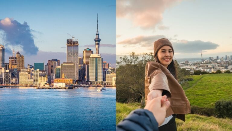 Auckland’s waterfront skyline and Sky Tower beside a traveler overlooking the city from a grassy hill.