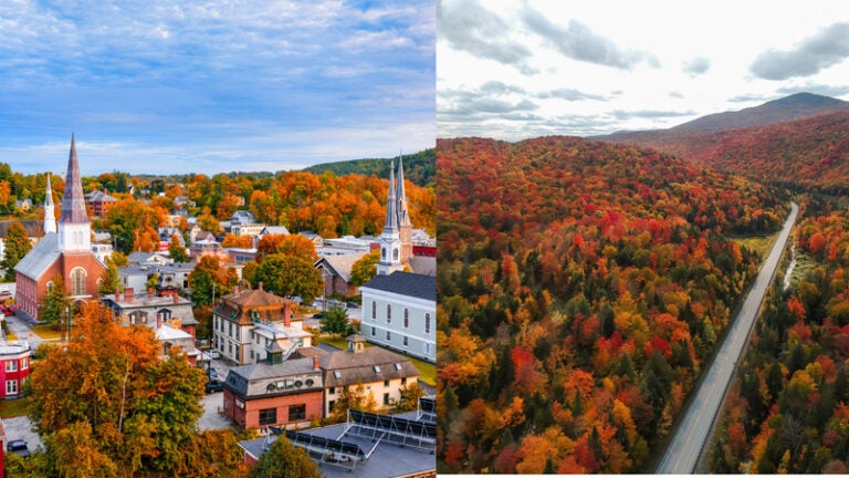 New England town and mountain road surrounded by red, orange, and yellow fall foliage