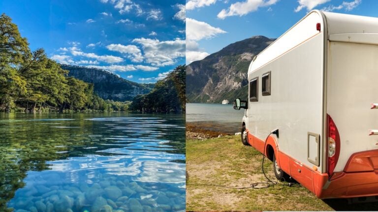 Clear tree-lined river beside a motorhome parked near the water