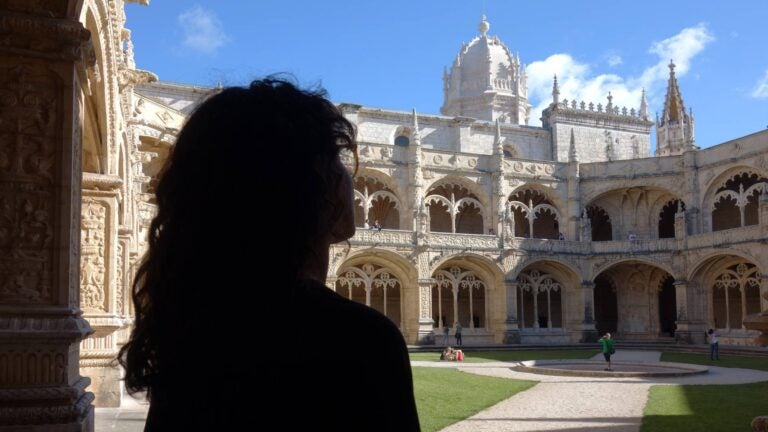 jeronimos monastery lisbon with a woman visiting it