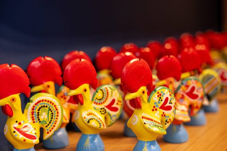 several roosters of barcelos with the traditional red and yellow colors