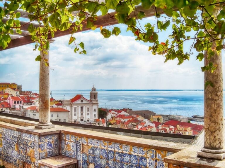 Lisbon miradouro with a church and the sea on the back