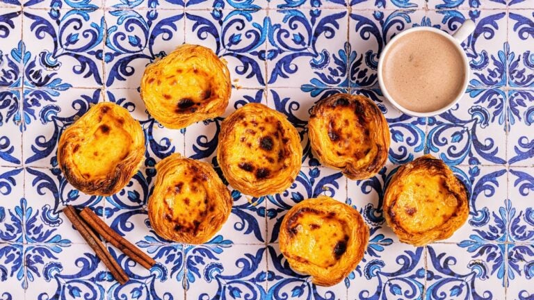 several pastel de nata with some hot chocolate
