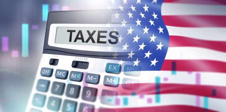 Flag of USA and a calculator with the word taxes written on it - what states don't tax social security