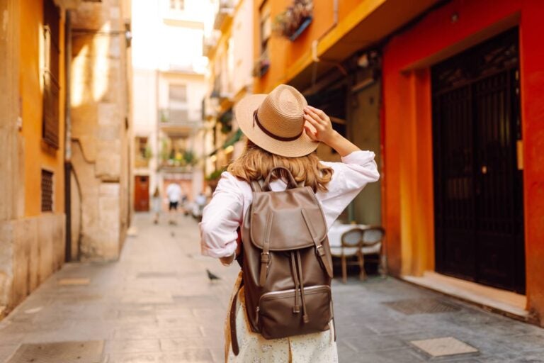 woman walking through traditional lisbon streets