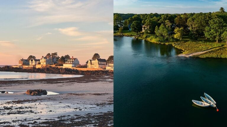 Coastal houses beside a beach and small boats moored near a wooded shoreline in Kennebunkport.