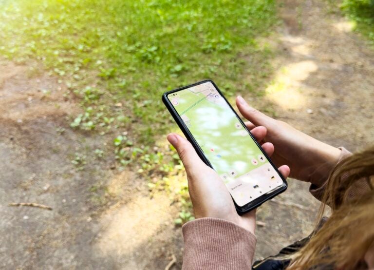 Person using a smartphone with a map application while traveling across Oregon.