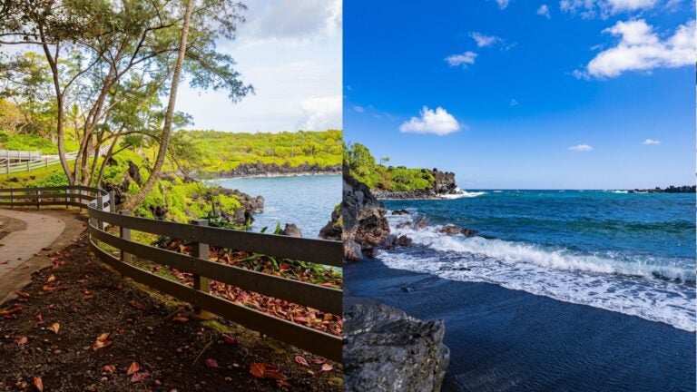 Coastal path overlooking Waiʻānapanapa and waves washing onto a black-sand beach surrounded by volcanic rock