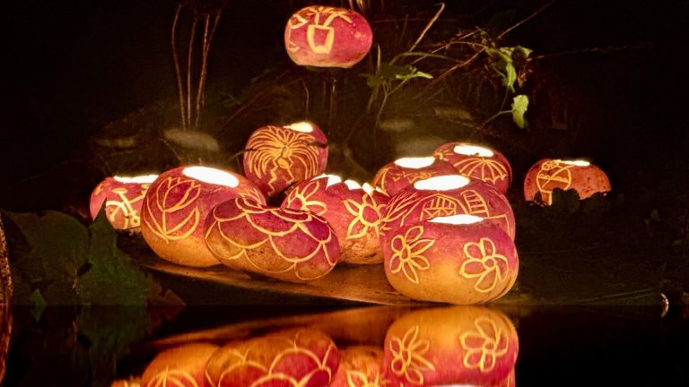 Hollowed-out turnips carved with detailed patterns, glowing from candles placed inside