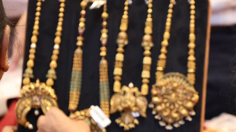 Shopper looking at gold jewelry at a store in India