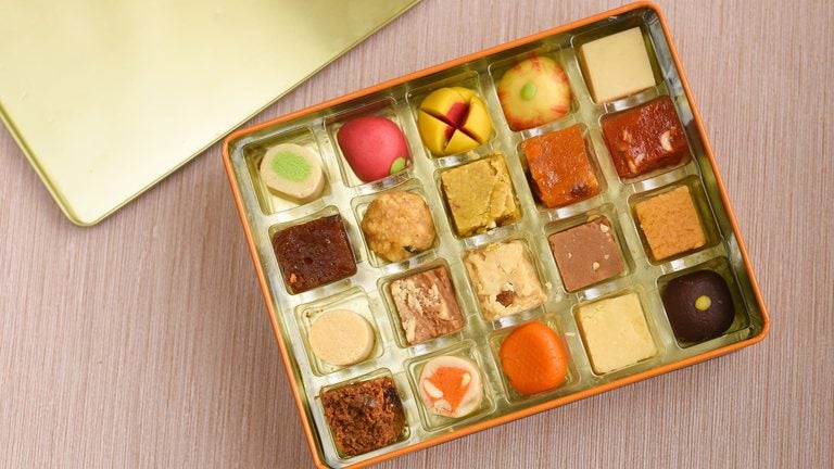 Box of assorted Indian sweets including peda and burfi