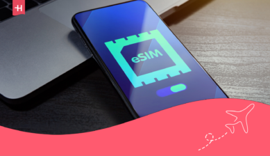 Smartphone displaying an eSIM symbol beside a laptop, with Holafly branding and an airplane illustration.