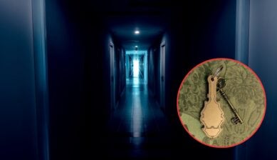 A dimly lit hotel hallway in cold blue tones stretches toward a bright light at the far end, lined with closed doors. A red-bordered circle inset shows an antique brass skeleton key attached to an ornate blank key tag, resting on green damask fabric.
