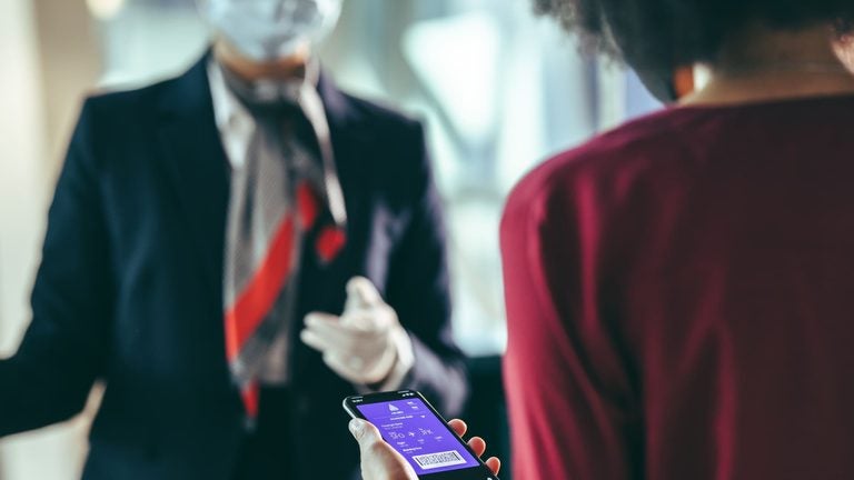 Traveler filling in an online form on a smartphone at the airport