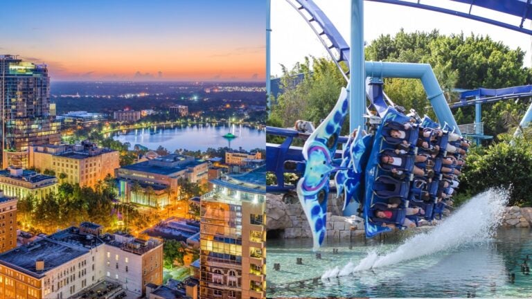 Downtown Orlando and Lake Eola at sunset, beside riders on a roller coaster above the water.